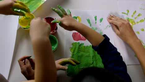 Children-hands-finger-painting-with-various-colors