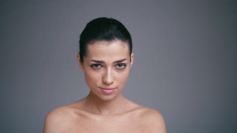 Shot-of-angry-young-woman,-looking-at-camera-with-strict-and-skeptical-expression