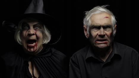 Elderly-man-and-woman-in-Halloween-costumes.-Dripping-blood-on-their-faces