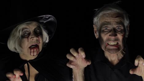 Elderly-man-and-woman-in-Halloween-costumes.-Witch-and-zombie