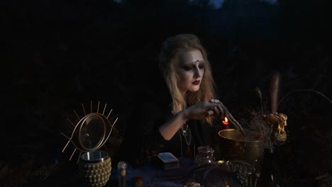 Halloween.-Young-Witch-Spells-At-The-Table.