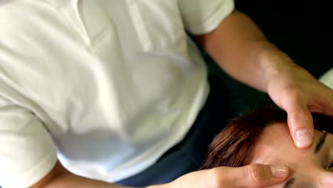 Physiotherapist-giving-head-massage-to-a-female-patient