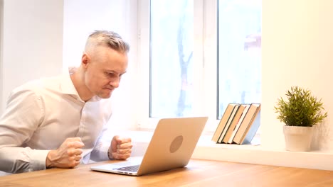 Angry-Middle-Age-Man-Working-on-Laptop