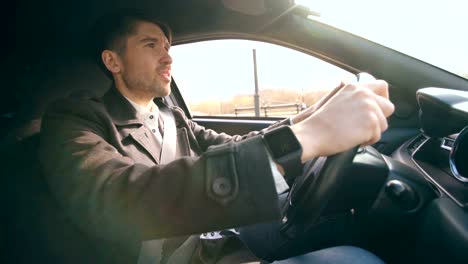 Young-business-man-driving-car-very-upset-and-stressed-after-hard-failure-and-moving-in-traffic-jam