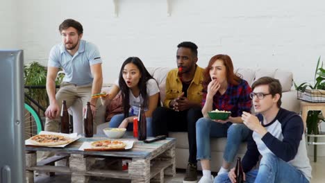 Slow-motion-of-Young-friends-watching-football-game-on-TV-together-at-home-and-disappointed-about-their-favourite-team-losing-match