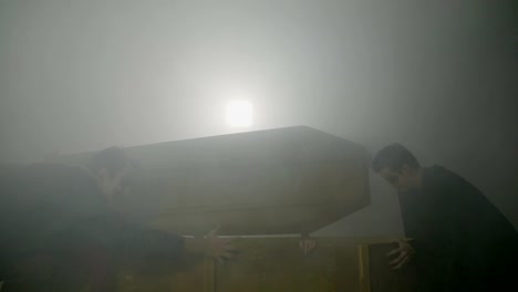Zombies-waking-up-female-creepy-vampire-opening-her-coffin-on-a-foggy-night-and-performing-a-halloween-ritual