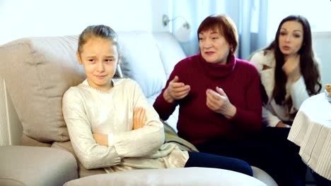 Little-girl-crying-while-mom-and-granny