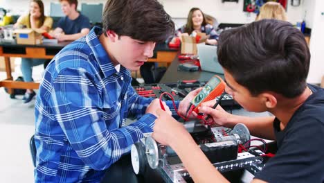 Male-High-School-Pupils-Building-Robotic-Vehicle-In-Science-Lesson