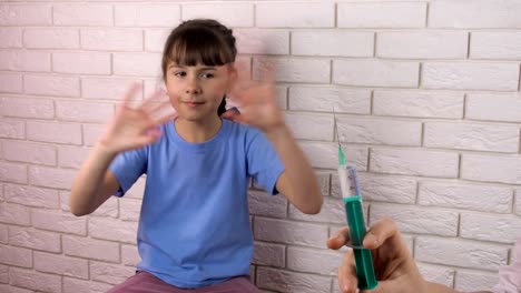 A-little-girl-is-injected-with-a-syringe