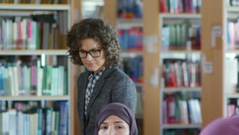 Female-Teacher-Helping-Arab-Woman-at-Lesson