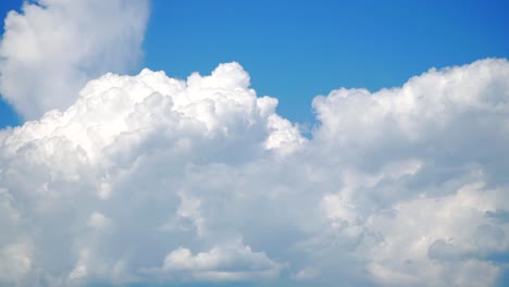 The-movement-of-white-clouds-against-a-blue-sky