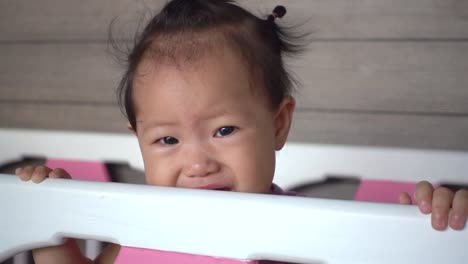 Asian-baby-girl-is-crying-on-baby-cot.