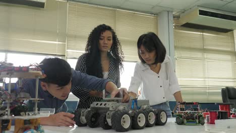 Team-of-electronics-engineer-working-together,-collaborating-on-a-project-to-build-robot.-People-with-technology-or-innovation-concept.