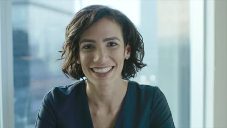 Portrait-of-a-Beautiful-Hispanic-Woman-Smiling-Charmingly.-Out-of-Focus-Cityscape-Background.