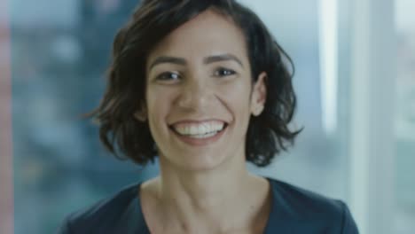 Portrait-of-a-Beautiful-Hispanic-Woman-Smiling-Charmingly.-Out-of-Focus-Cityscape-Background.