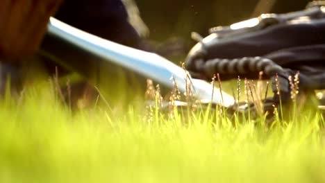 Equipment-for-the-sport-of-baseball-laying-on-the-lawn