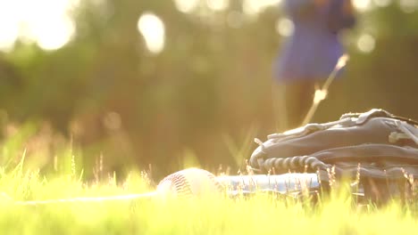 Equipment-for-the-sport-of-baseball-laying-on-the-lawn