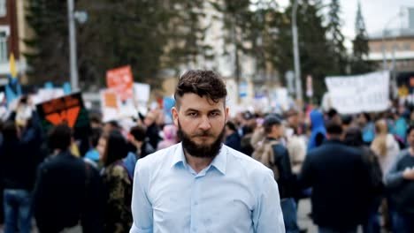 European-person-is-talking-in-megaphone-close-up.-People-scream-at-the-rally-4k.