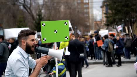 Shooting-on-a-shooter-from-a-megaphone.-Many-people-on-background-in-slow-motion