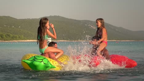 Slow-motion-view-of-fathers-and-daughters-having-a-play-fight-in-sea.