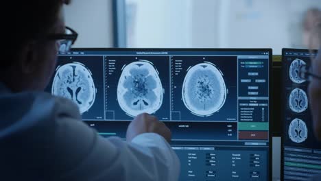 In-Medical-Laboratory-Patient-Undergoes-MRI-or-CT-Scan-Process-under-Supervision-of-Radiologist-in-Control-Room,-He-Watches-Procedure-and-Monitors-Brain-Activity-Results.