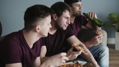 Jungs,-die-Pizza-und-Bier-beim-sportlichen-Wettkampf