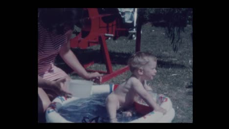 1971-Mother-plays-with-naked-infant-son-in-kiddie-pool