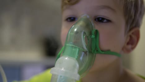 Boy-makes-inhalation.-medical-equipment