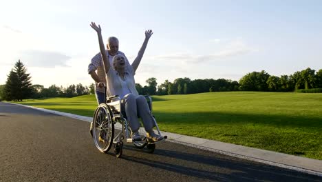 Retired-couple,-wife-on-wheelchair-enjoying-life