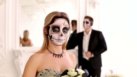 Girl-with-a-terrible-make-up-in-the-form-of-a-skull-in-a-room-with-a-man-in-suit