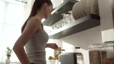 Woman-Cooking-Toasts-On-Breakfast-At-Modern-Light-Kitchen