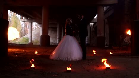 Scary-couple-with-creepy-makeup-on-Halloween-with-fire-and-burning-torches.