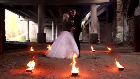 Scary-couple-with-creepy-makeup-on-Halloween-with-fire-and-burning-torches.