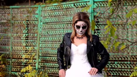 Girl-with-a-creepy-make-up-for-Halloween-on-the-background-of-an-old-rusty-fence