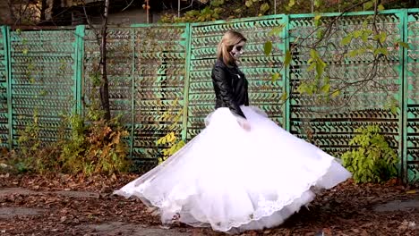 Girl-in-wedding-dress-with-a-terrible-make-up-spinning-in-the-autumn.-Halloween