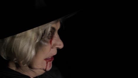 Old-witch-Halloween-makeup.-Elderly-woman-portrait-with-blood-on-her-face.