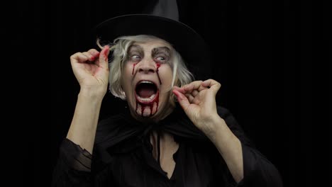 Old-witch-Halloween-makeup.-Elderly-woman-portrait-with-blood-on-her-face.