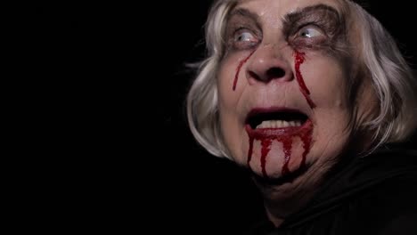 Old-witch-Halloween-makeup.-Elderly-woman-portrait-with-blood-on-her-face.