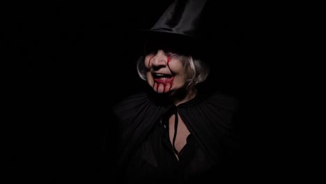 Old-witch-Halloween-makeup.-Elderly-woman-portrait-with-blood-on-her-face.