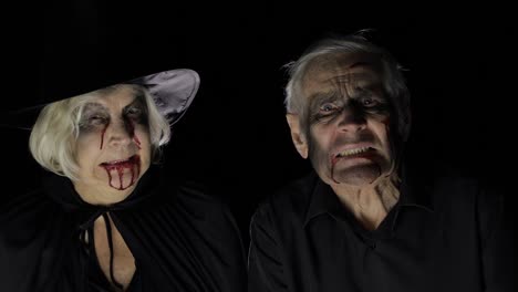 Elderly-man-and-woman-in-Halloween-costumes.-Dripping-blood-on-their-faces