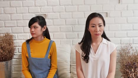 Asian-family-Mom-and-teenage-daughte-are-feeling-stressed-and-angry,-not-talking-after-dispute-at-home.-Family-conflict-concept