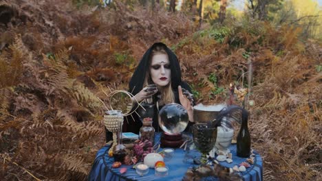 Halloween.-Young-Witch-Spells-At-The-Table.