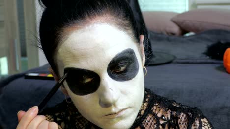 Woman-apply-Halloween-make-up.Halloween,Day-of-the-Dead--makeup-ideas-concept