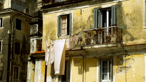 Clean-clothes-and-linen-hanging-on-a-clothesline-to-dry-outdoors-in-streets.-4K