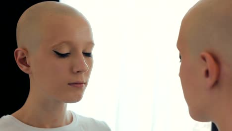 Sad-woman-suffering-from-cancer-looking-at-herself-in-the-mirror