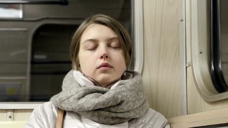 Tired-young-woman-try-to-sleep-in-subway