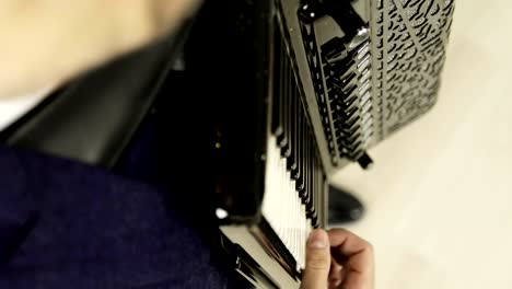 Close-up-of-a-man's-right-hand-playing-on-a-black-accordion.