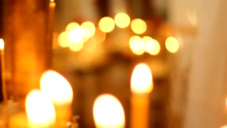 Bright-church-candle-lights-flickering,-illuminating-path-to-god-for-lost-souls