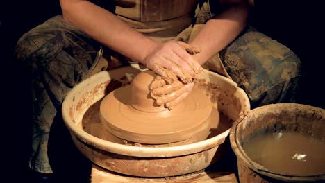 Potters-hands-get-washed-after-working-on-a-wheel.