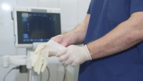 Close-up-professional-doctor-wearing-medical-gloves.-Sterile-gloves-on-the-hands-of-a-doctor,-medical-tools-in-a-hospital